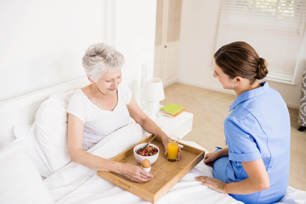 Nurse taking care of suffering senior patient at home